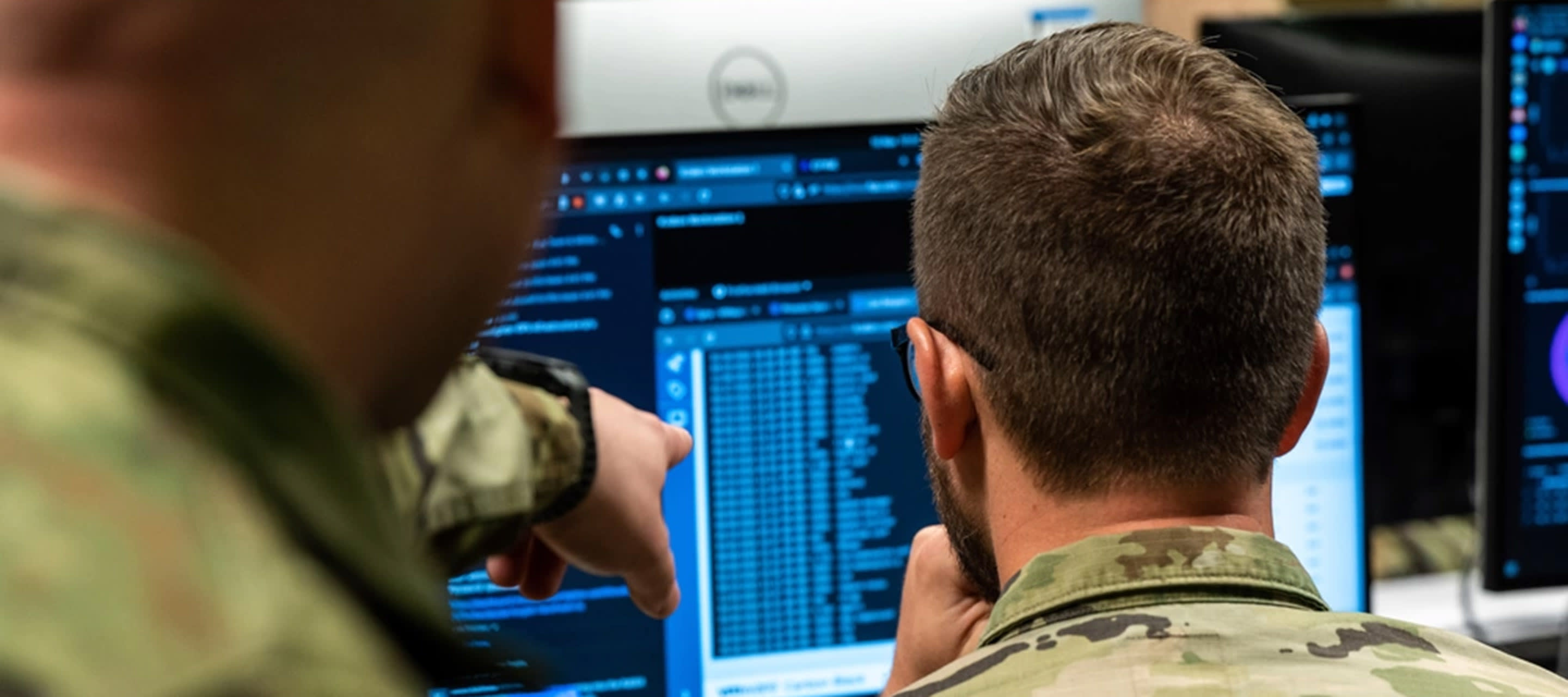 two soldiers looking at their computers