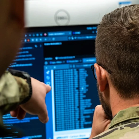 two soldiers looking at their computers