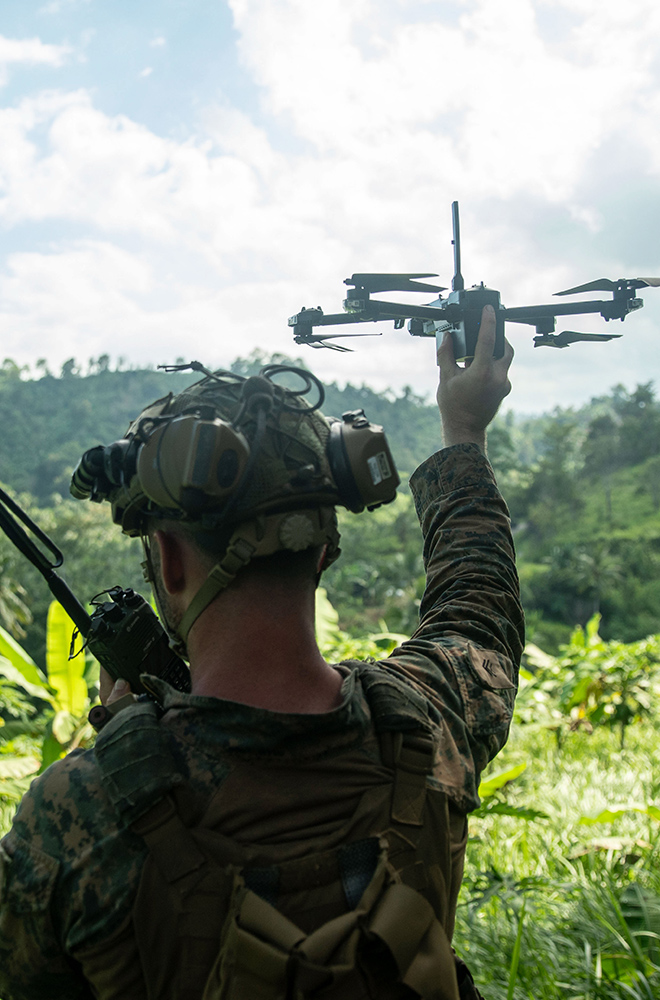 soldier holding up a drone