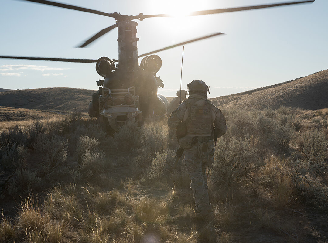soldier walking towards helicopter 
