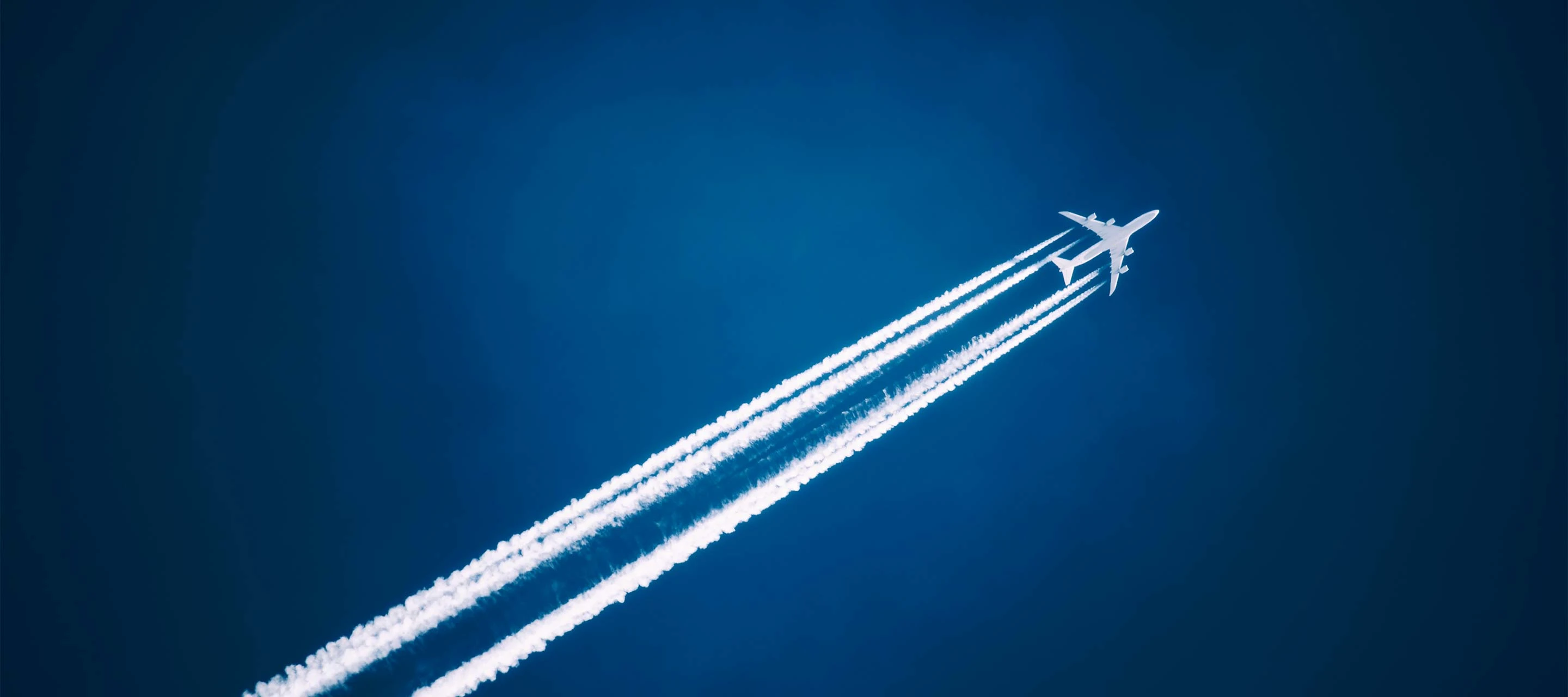 image shows plane with trail flying