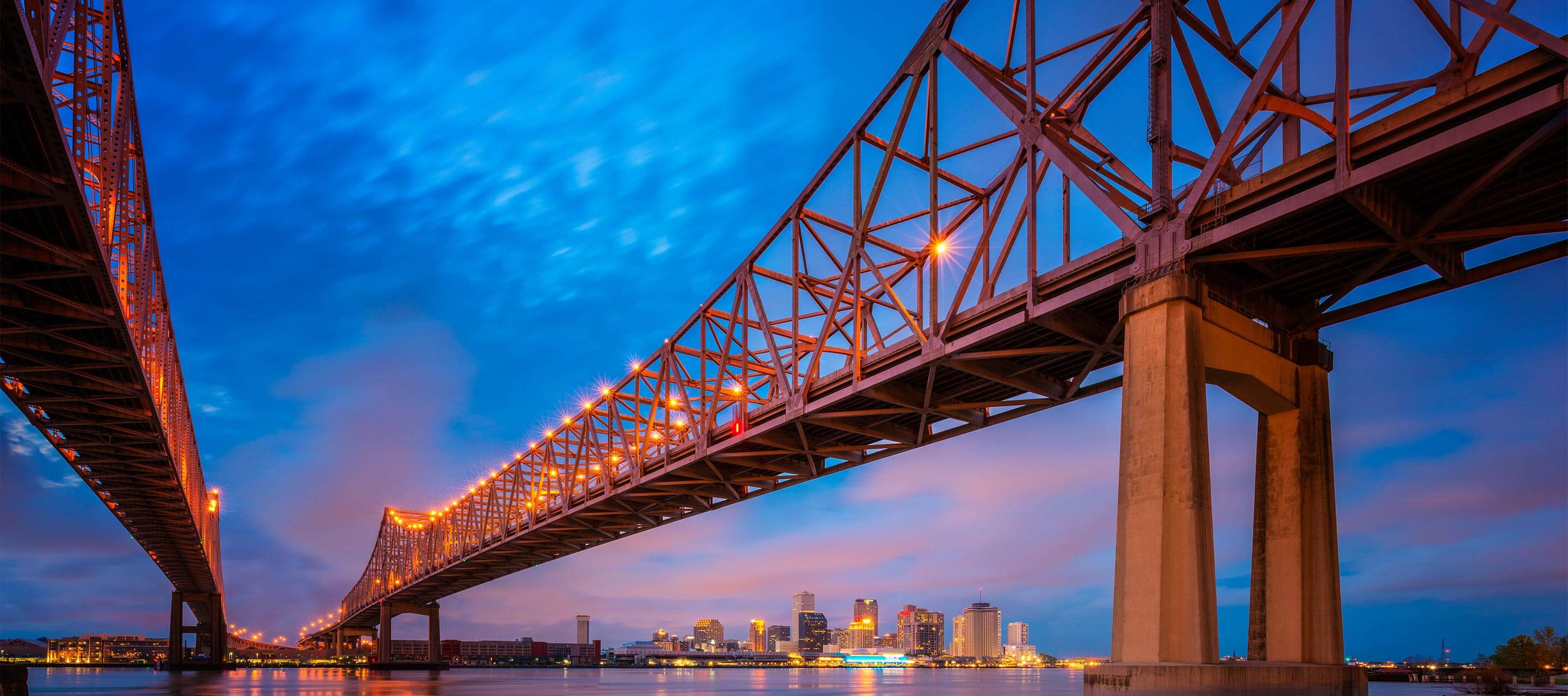 image shows view of bridge with deep blue skies