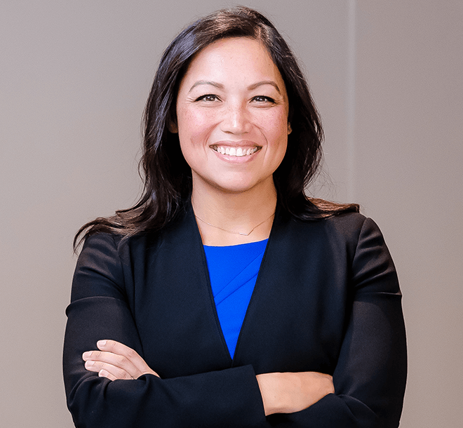 smiling woman with arms crossed