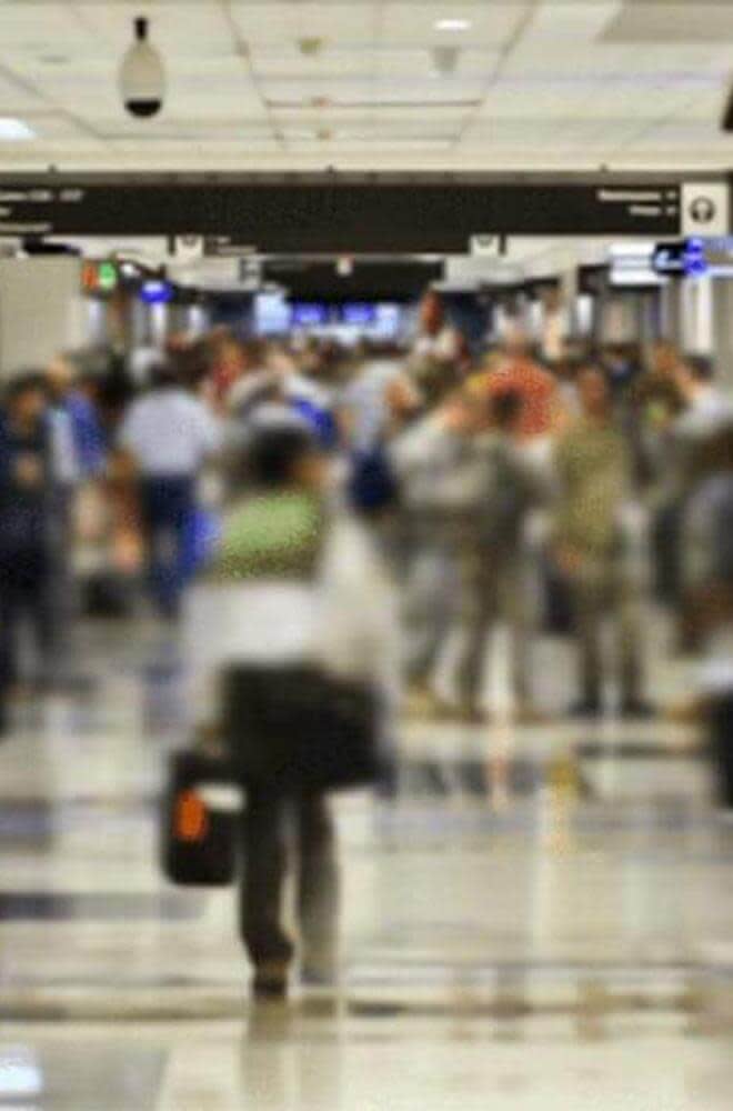 blurred image of people walking in airport