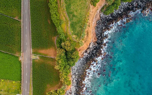 image shows road on land split with sea