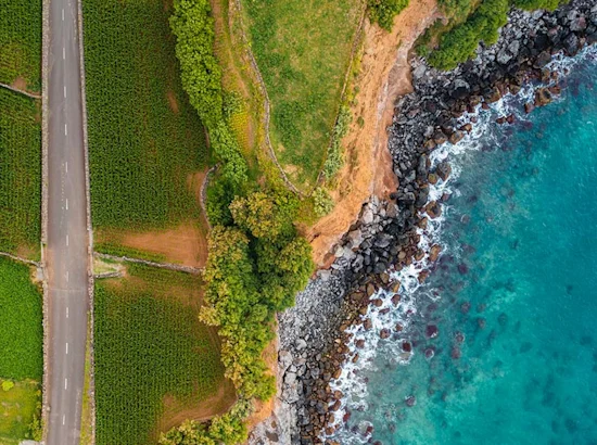 image shows road on land split with sea