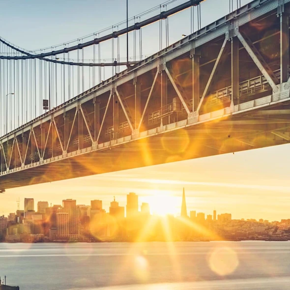 image of a bridge over water at sunset