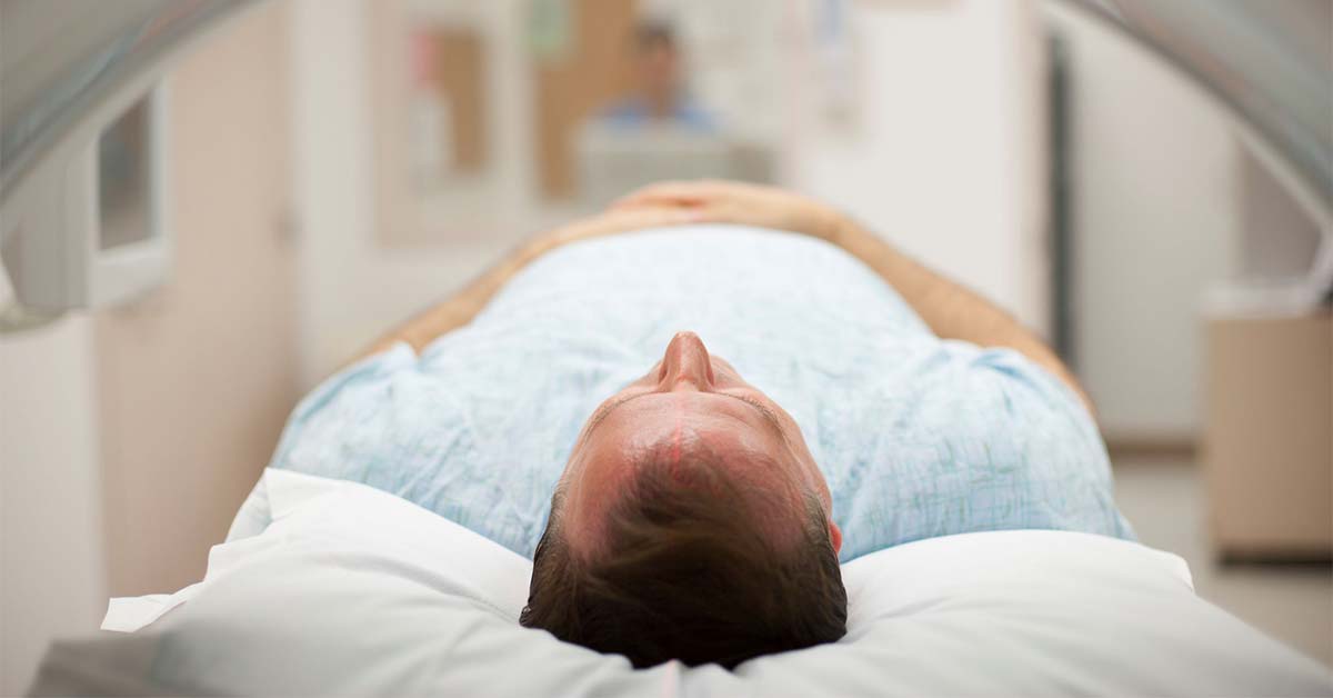 man going into MRI scan