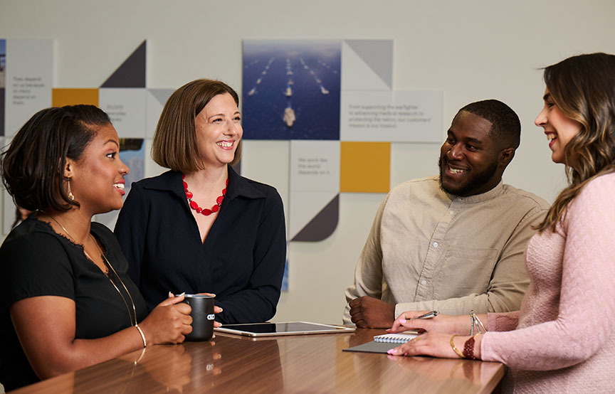 GDIT employees around a table