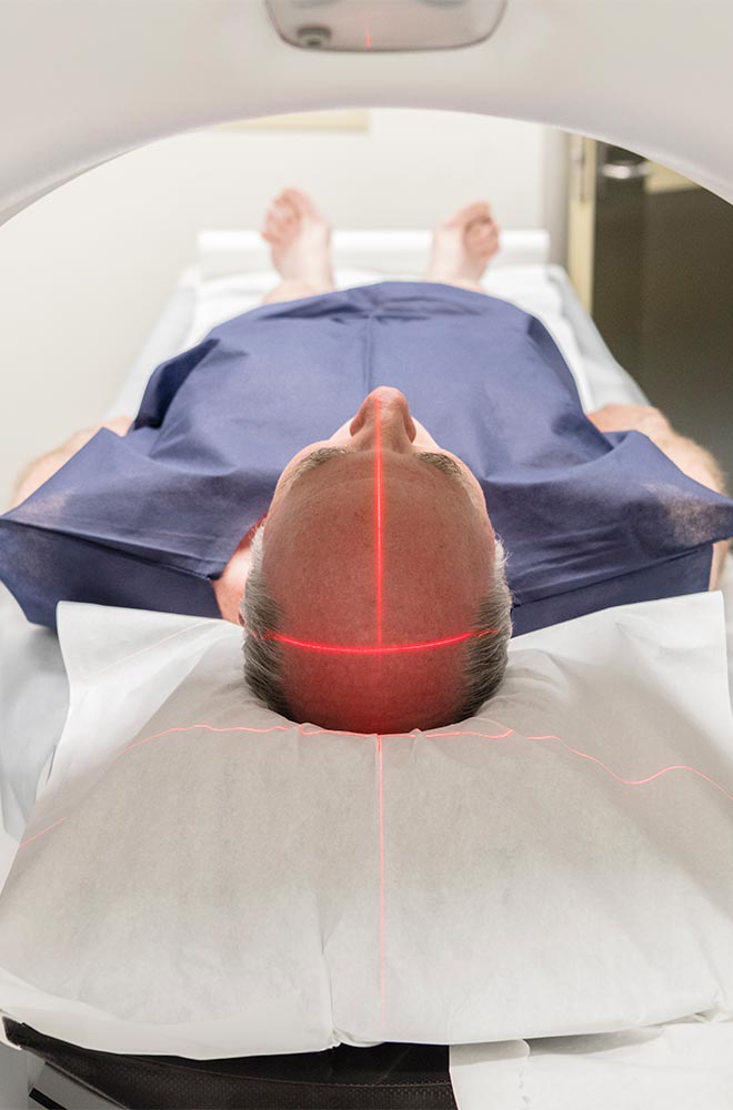 image shows man entering a MRI scan