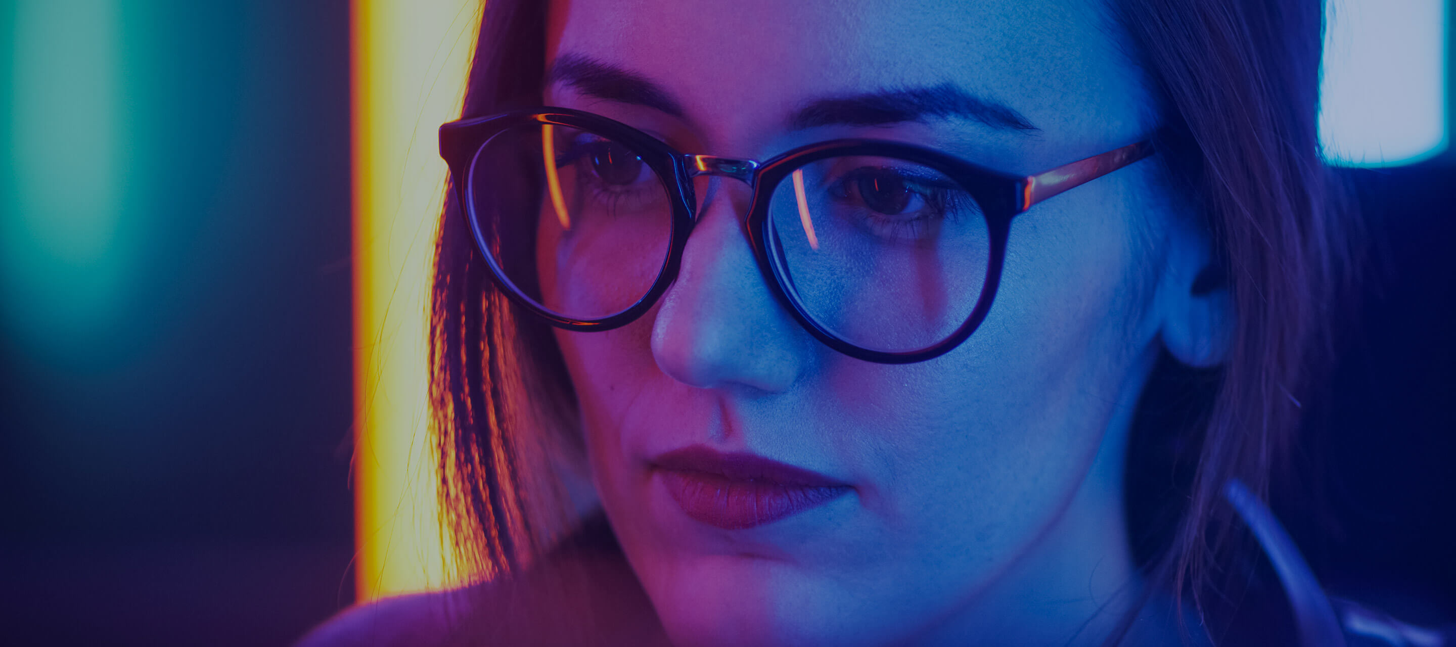 woman in glasses looking at computer