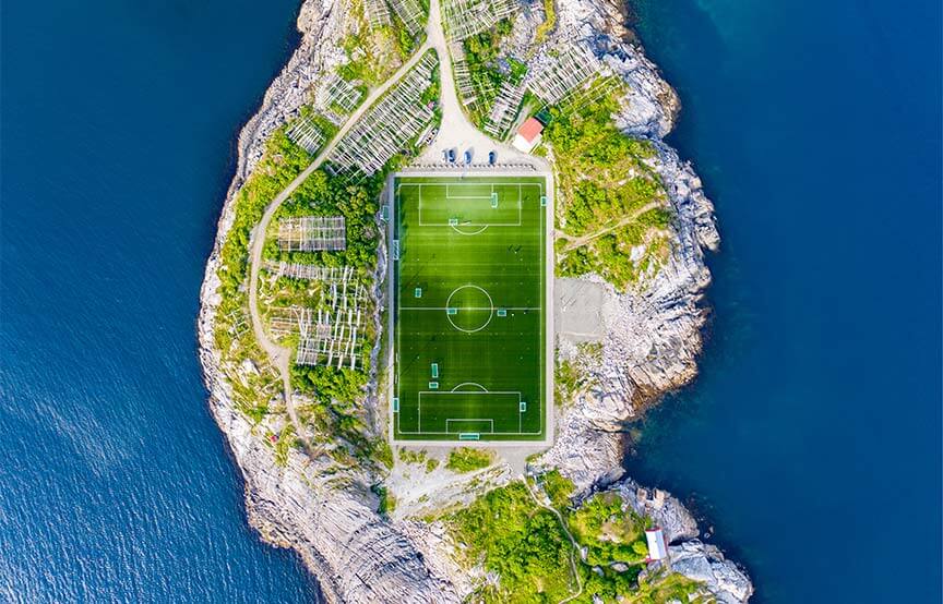 field on island surrounded by water