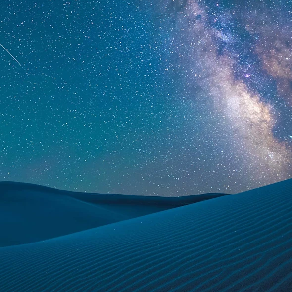 image shows night sky with stars and valleys