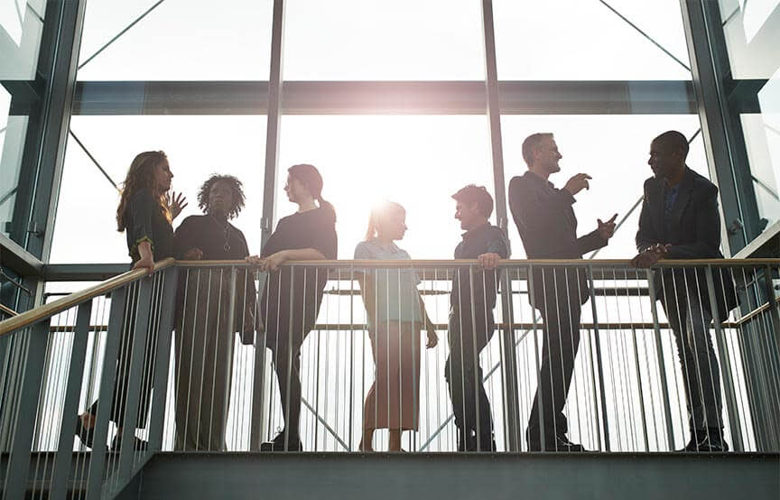 group of people standing around balcony 