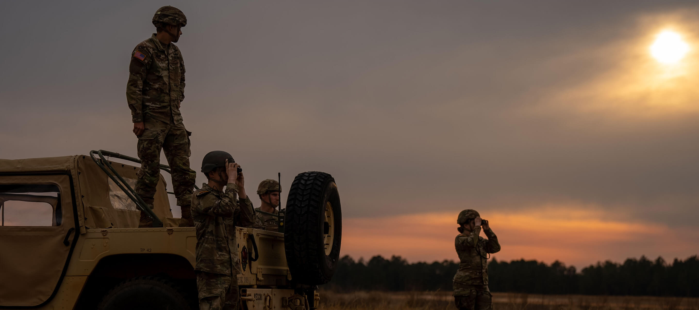 soldiers by a vehicle looking onwards