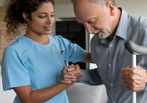 image shows a nurse helping someone stand with crutches