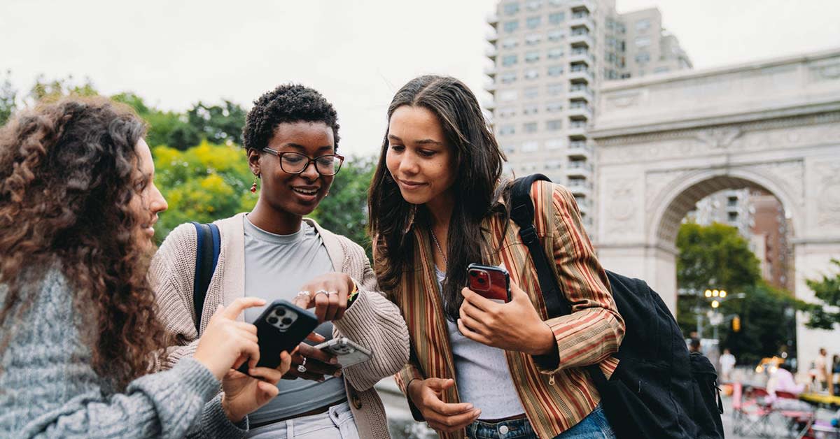 students in NYC looking at their phones