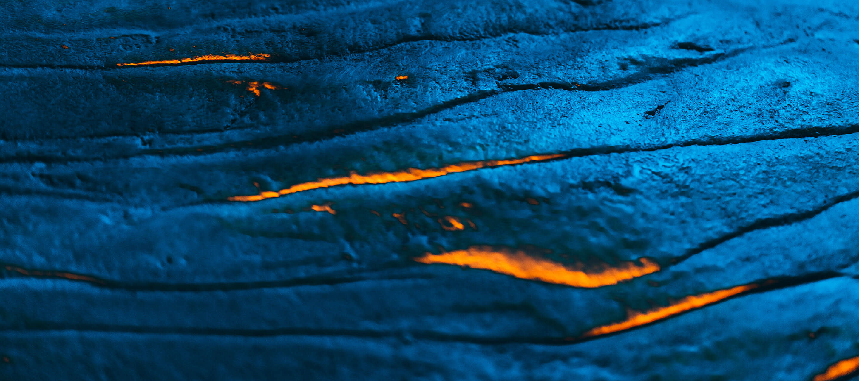 Textured metallic colored lava field with hot burning magma