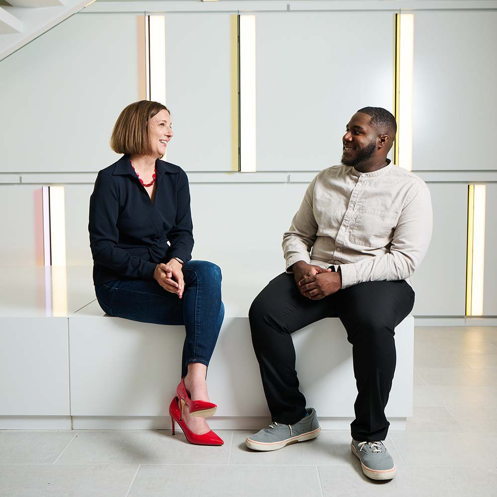 two coworkers chatting in the office