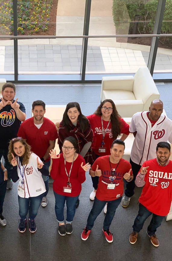 People cheering on on the Washington Nationals at the GDIT office