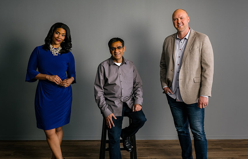 GDIT employees against grey wall