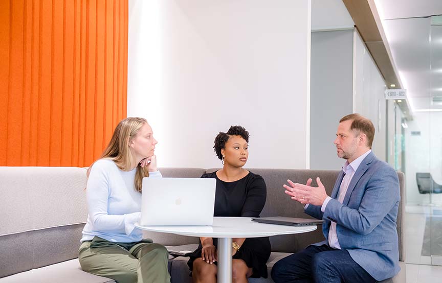 coworkers gathered in the lounge for a discussion