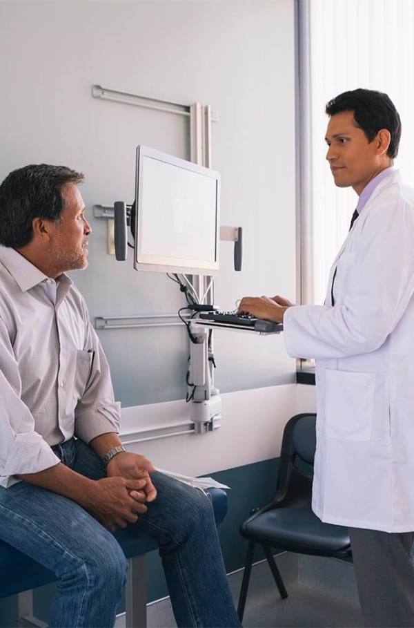 doctor talking to patient while filling out chart
