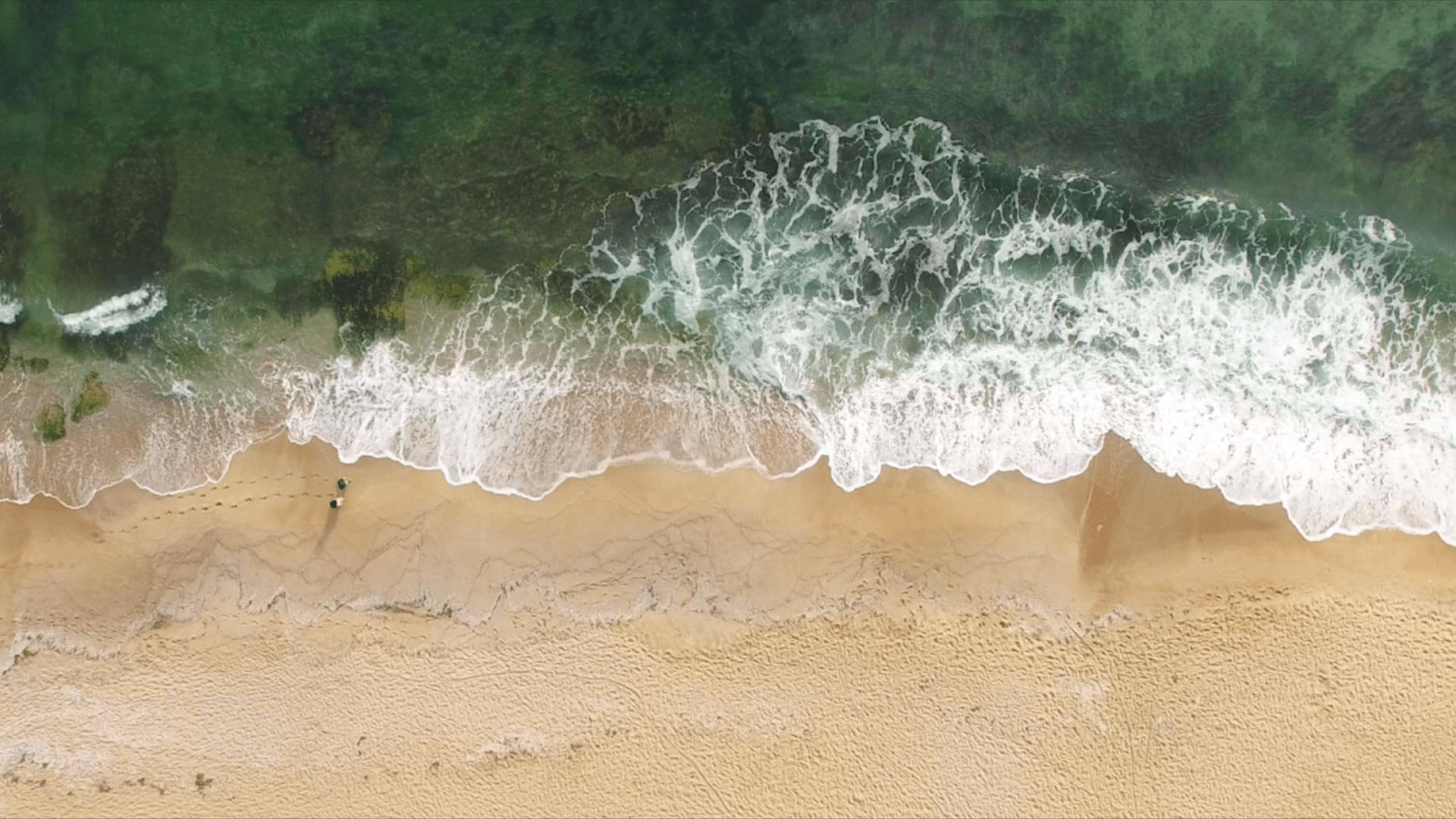 waves crashing against sand