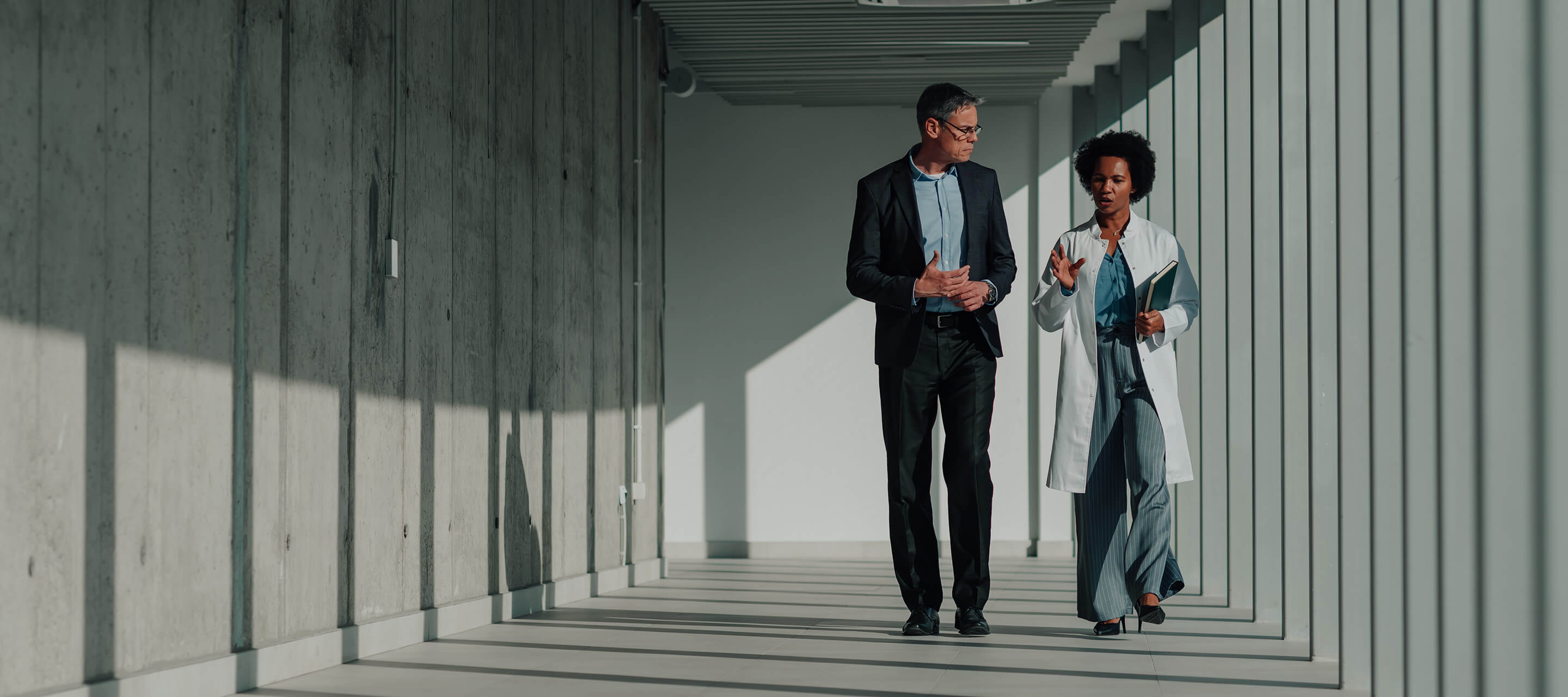 medical professional and man walking in hall