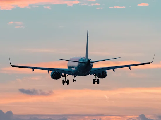 plane in the sky with colorful clouds