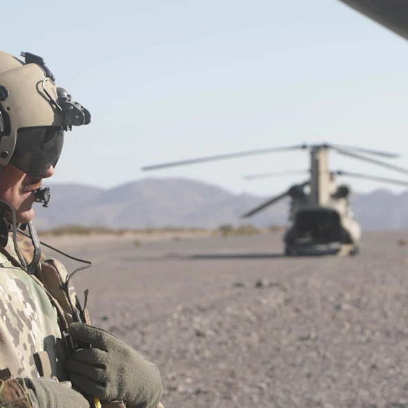 soldier on the grounds, aircraft in background