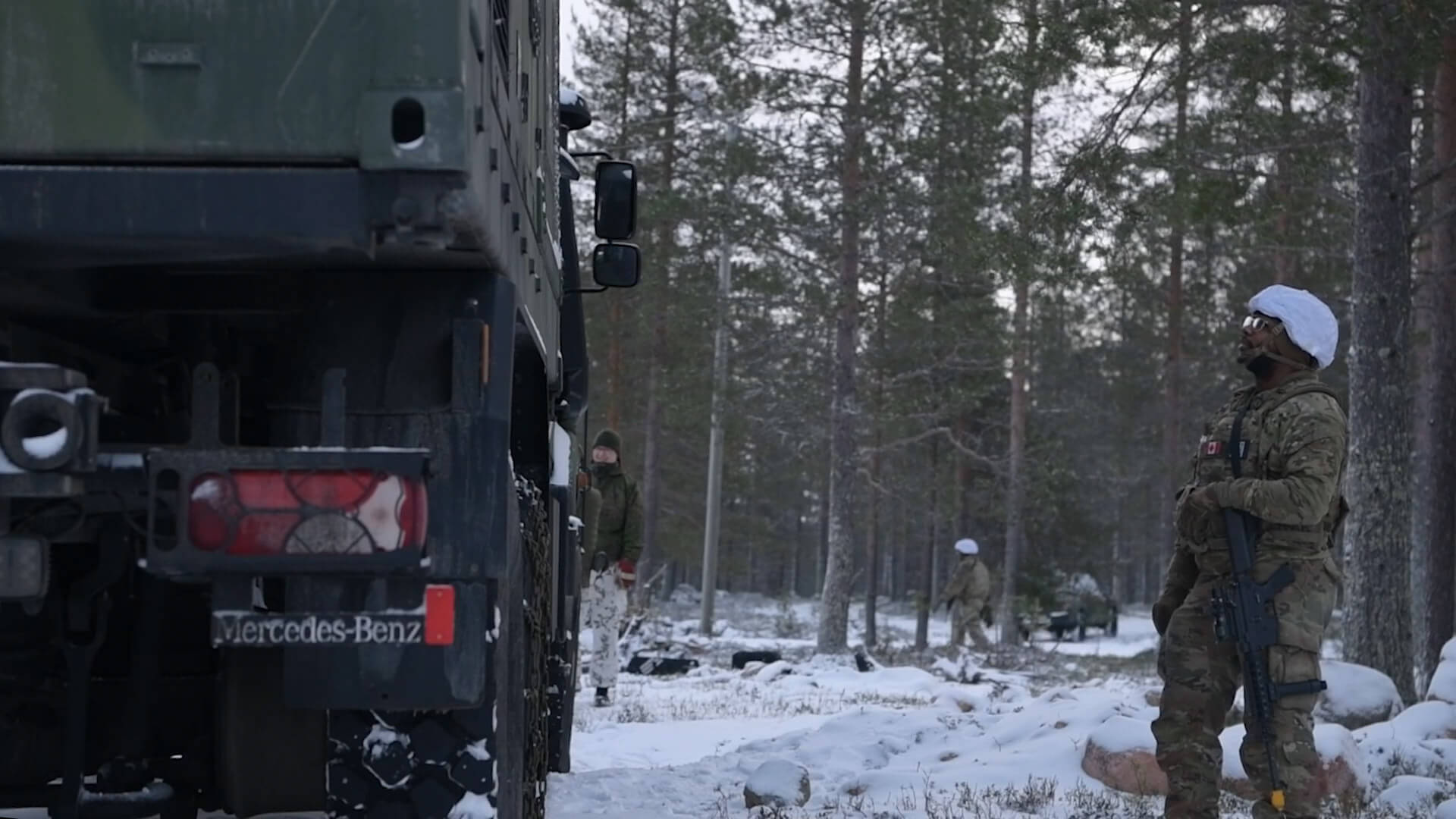 soldier facing a truck in the snow
