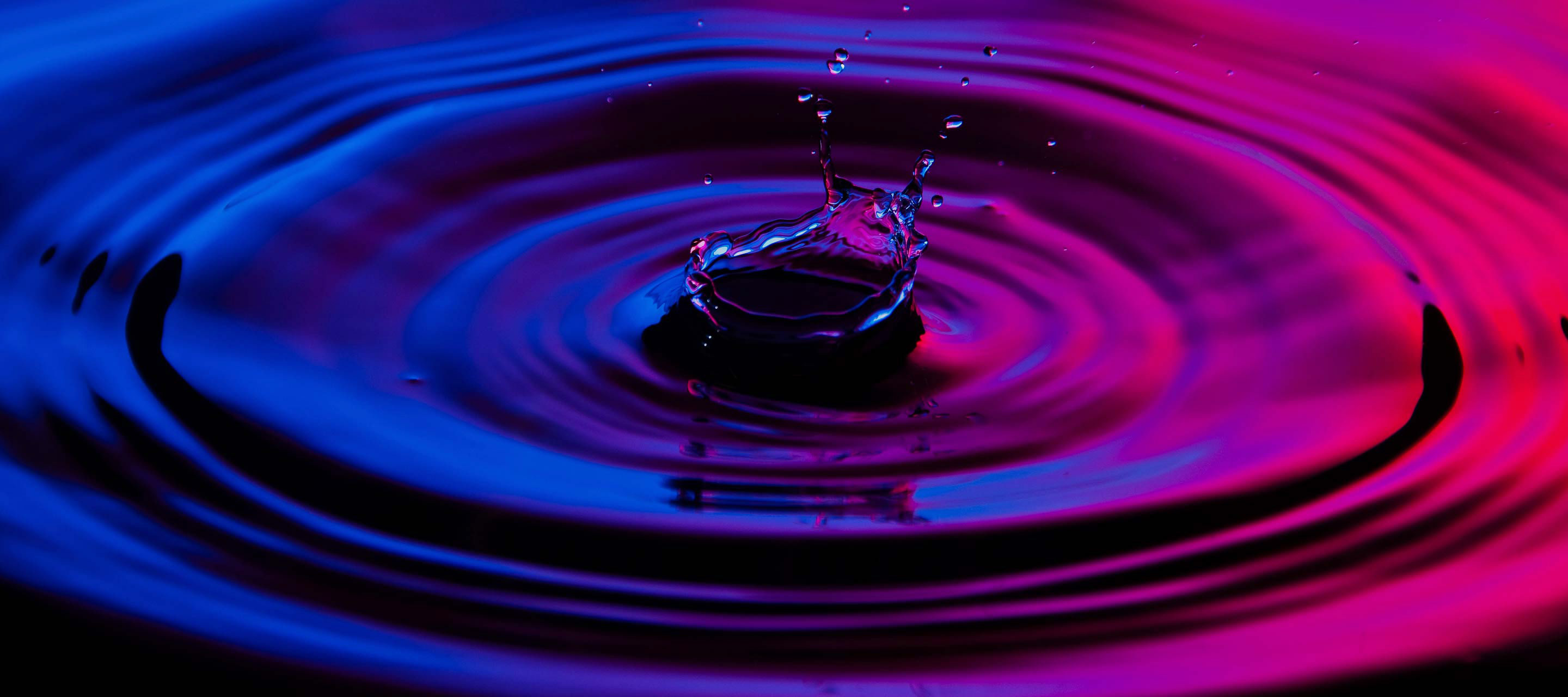 droplet in pink/purple water