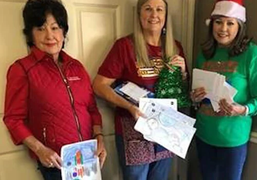 3 people standing next to donations