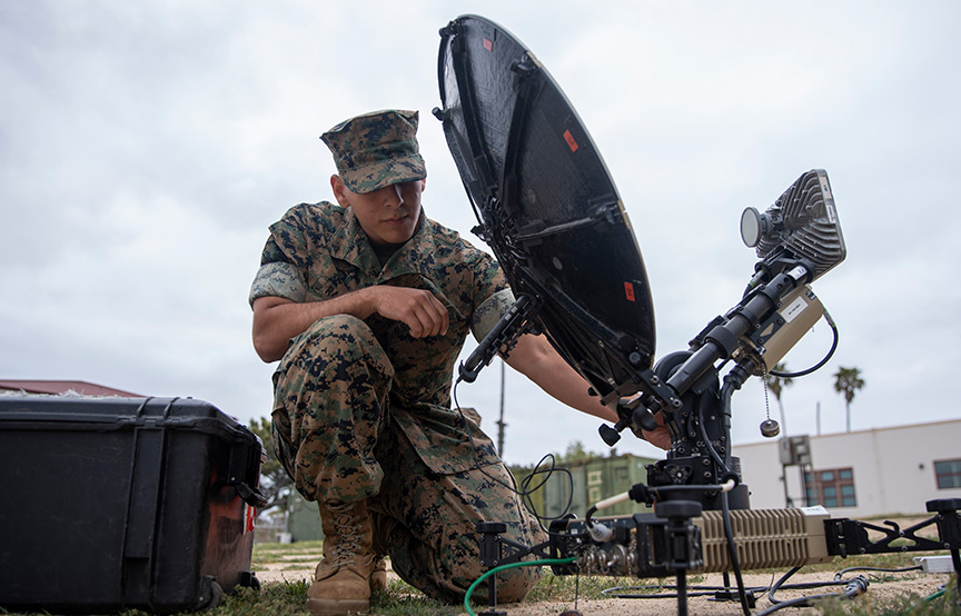 soldier by a satellite 