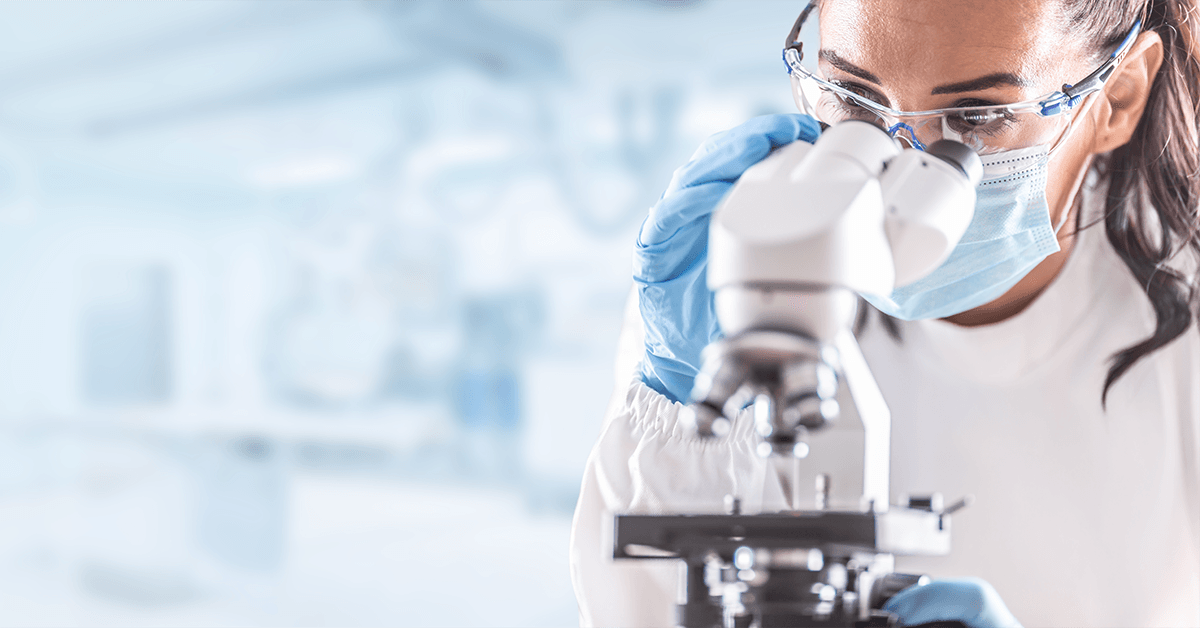 female scientist looking into a microscope