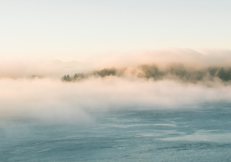 ocean with fog over it