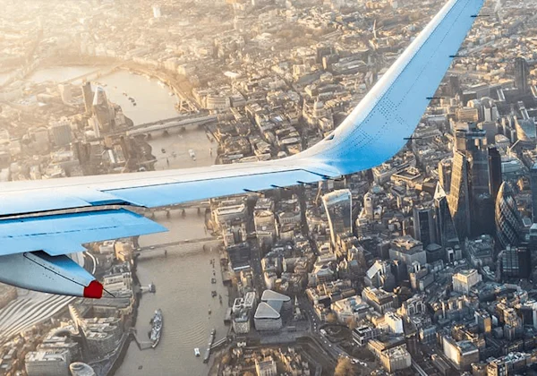 airplane wing over the city sky