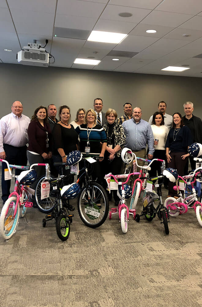 group of people in front of kids bikes that have been assembled