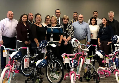 group of people in front of kids bikes that have been assembled