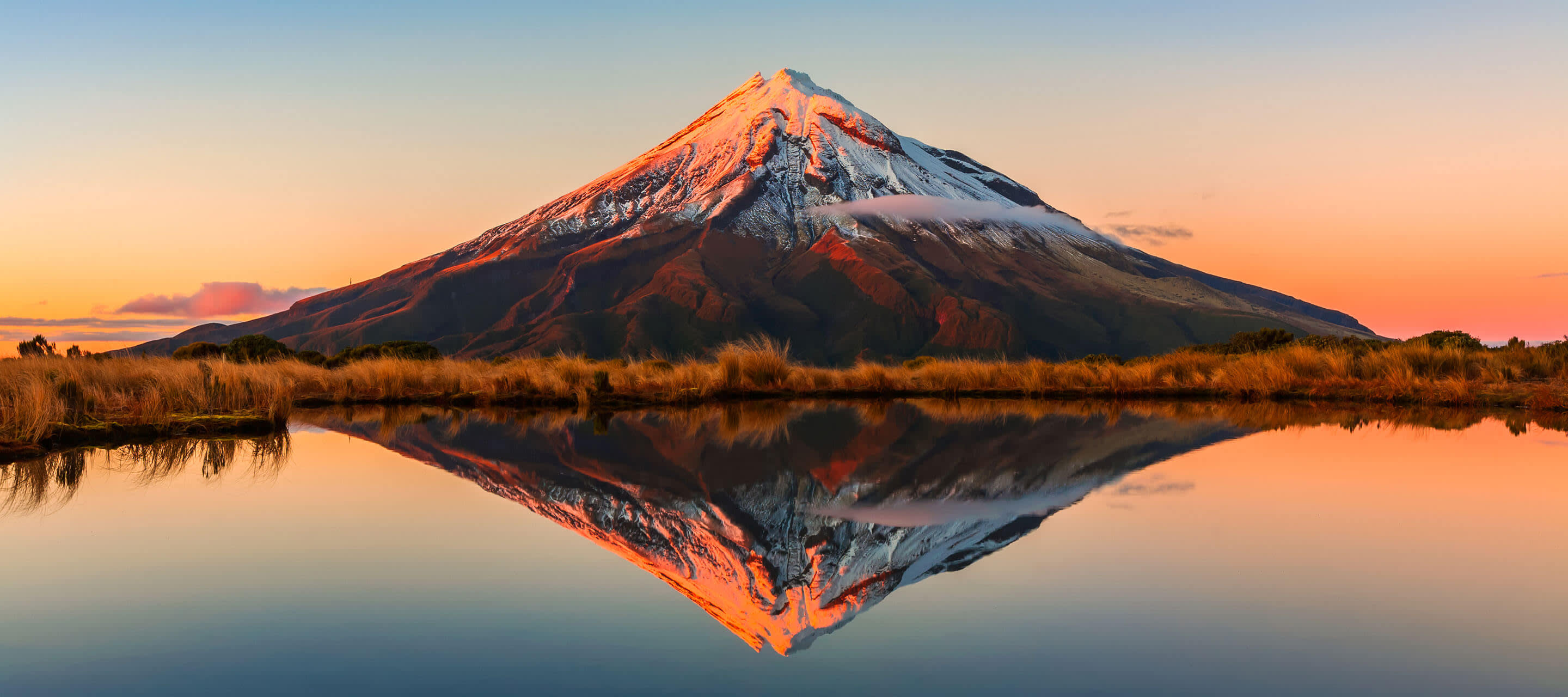 Mountain at sunset with a reflection in a body of water