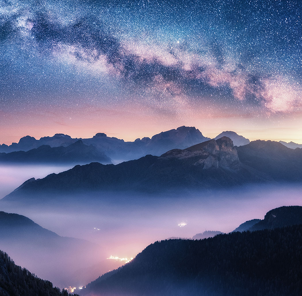 purple sky full of stars above mountains