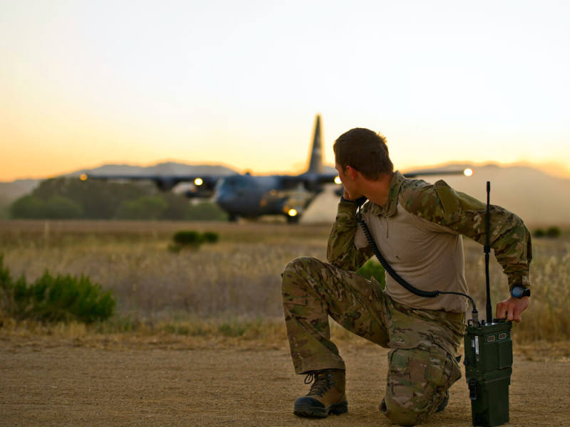 Solider looking at a plane