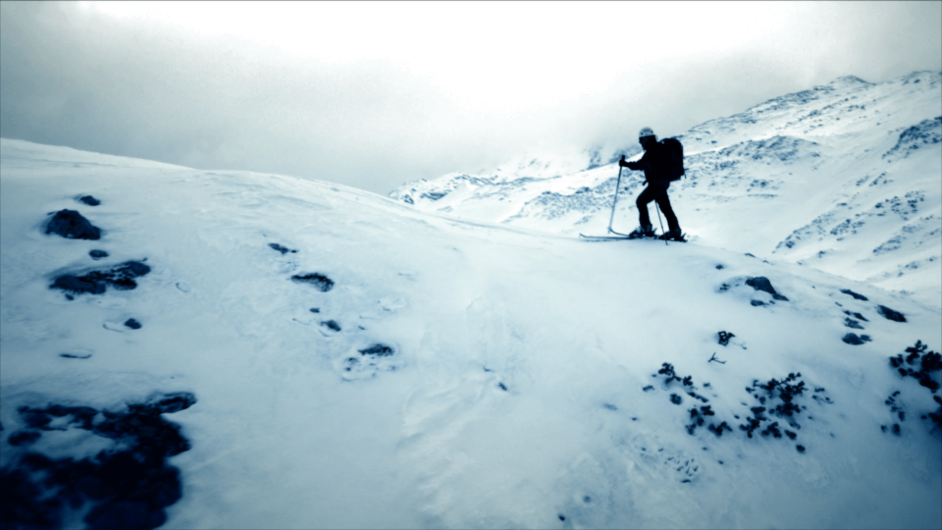 man walking in snow mountain