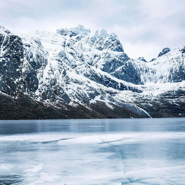 snowy mountains overlooking a frozen lake