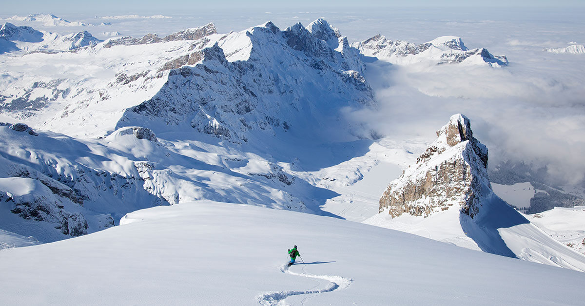 skier skiing down snowy mountains 