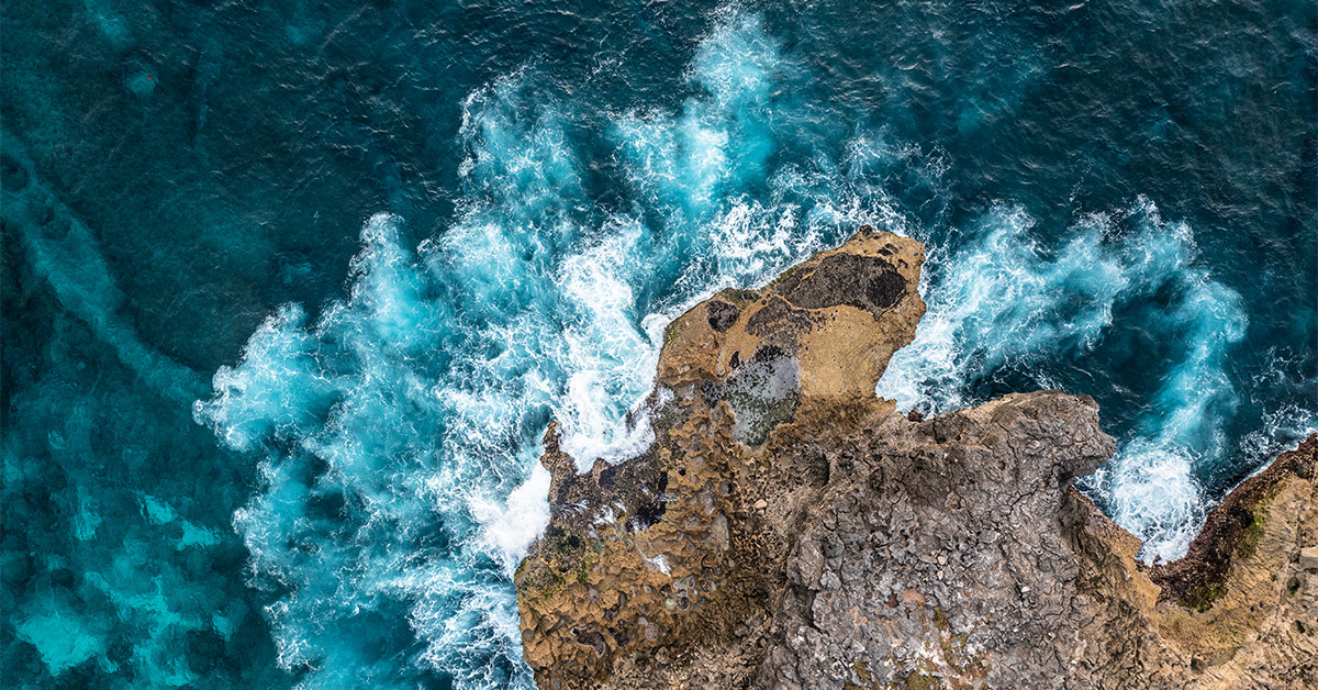 waves crashing against bedrocks