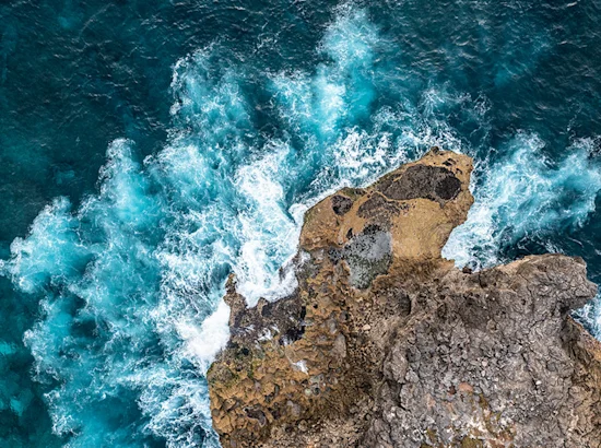 waves crashing against bedrocks