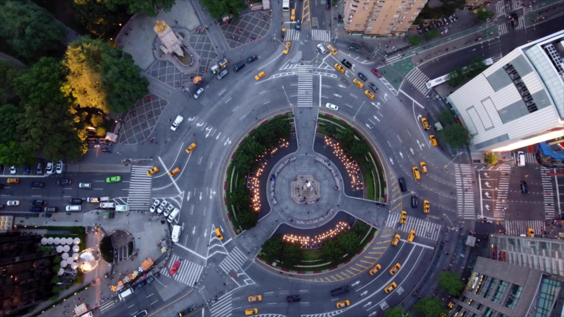 aerial view of taxis driving around a roundabout 