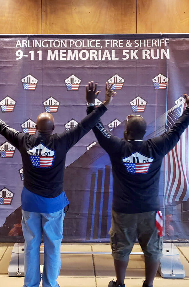 two people standing with this arms raised